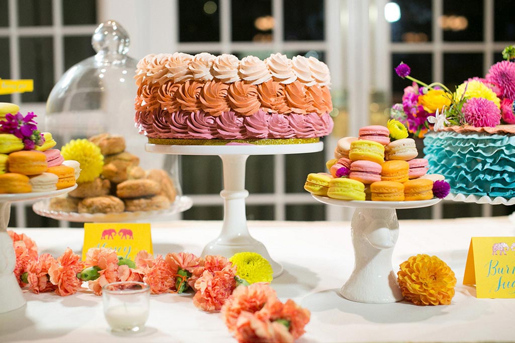 Ruffled buttercream wedding cake and colorful macarons