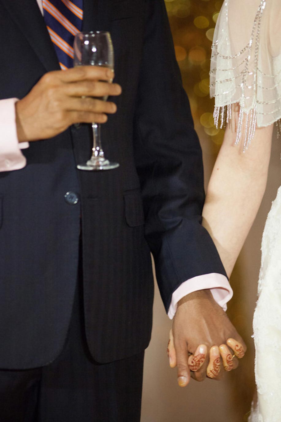 Bride and groom holding hands during wedding toast