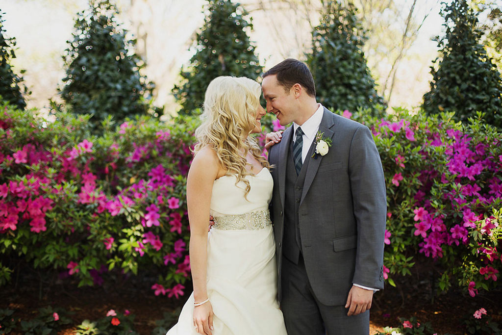 Bride and groom take a wedding day portrait in a garden at The Dallas Arboretum