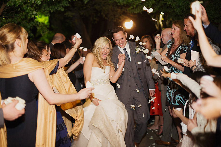 Bride and groom wedding reception grand exit with petals