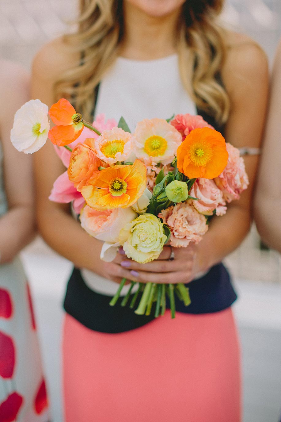 Bridesmaid with pink and orange bouquet and mix and match dress