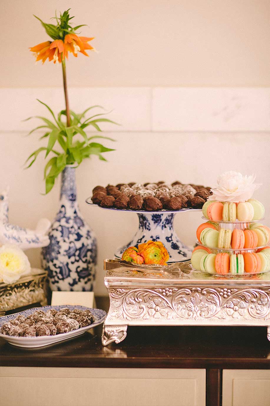 Wedding dessert table with macaroons and chocolate truffles on blue and white porcelain