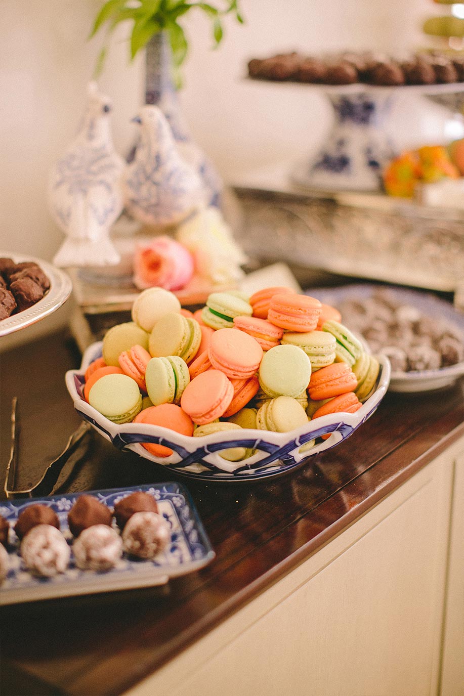 Wedding dessert table with macaroons and chocolate truffles on blue and white porcelain