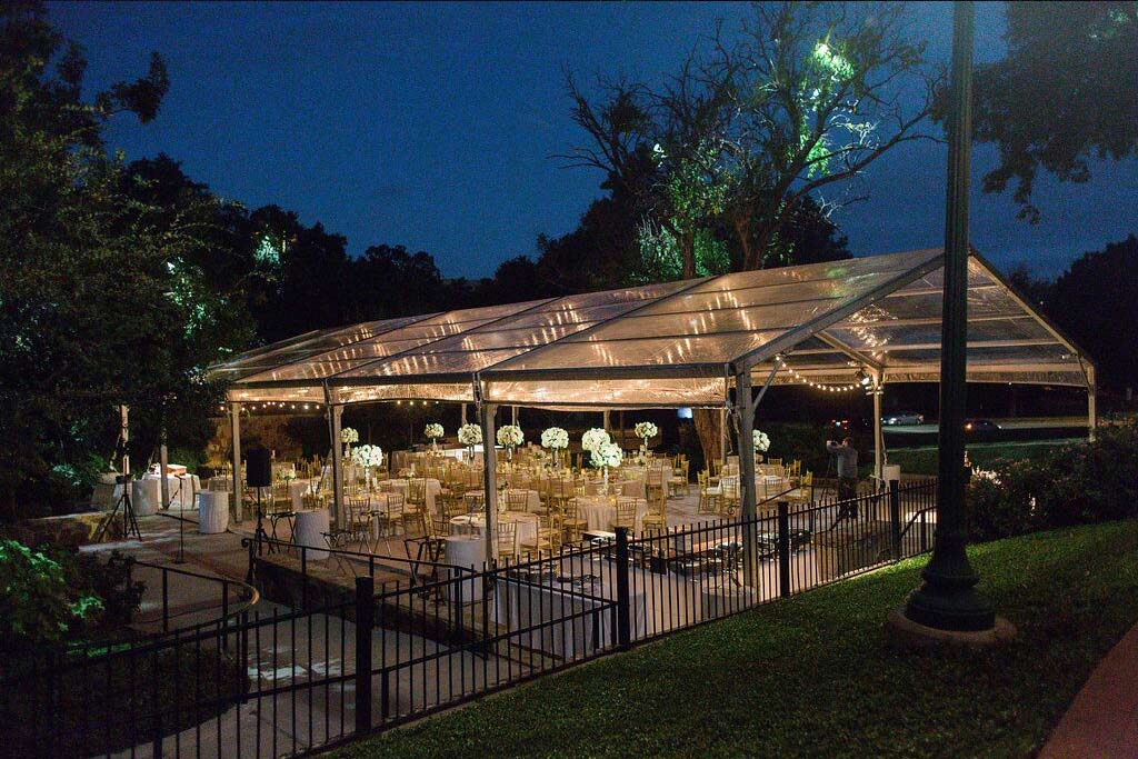 Wedding clear tent at Arlington Hall lower garden with cafe lights