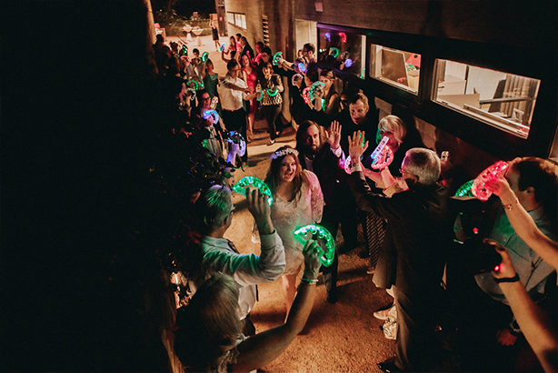 Bride and groom exit their wedding reception at the Trinity River Audubon Center in Dallas with LED tambourines