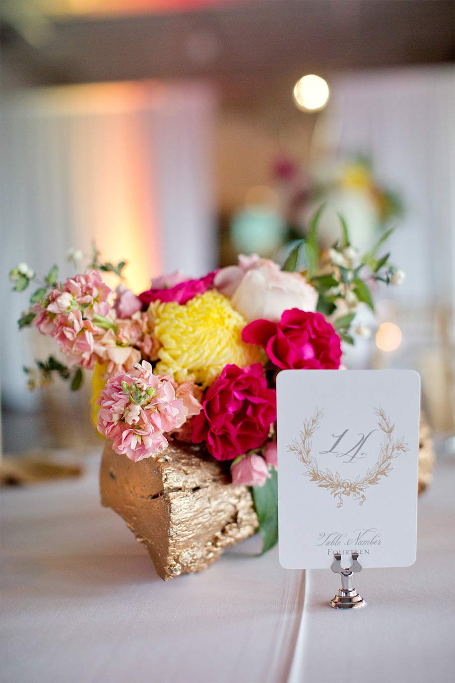 Gold log wedding centerpiece and laurel wreath table number